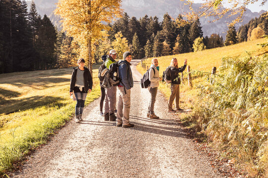 Group of friends hiking in the mountains in the fall. Lenggries, Bavaria, Germany