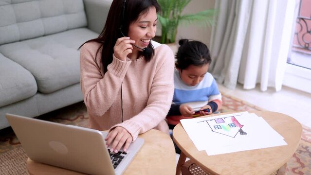 Asian mother and child having enjoy together while working at home. Family love concept