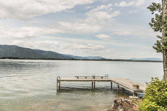 Landscape shot of lake and mountains with dock in the foreground. Sand Point, Idaho, USA
