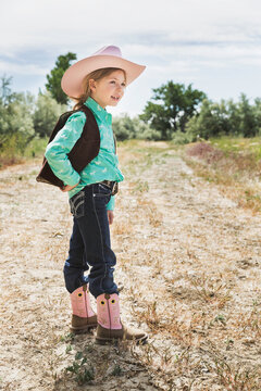 Young girl dressed in cowboy dress with hat and boots. Cody, Wyoming, USA