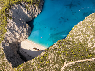 Fototapeta premium Aerial drone view of Navagio beach on Zakynthos island, Greece. Shipwreck Beach or Agios Georgios. is exposed cove in the Ionian Islands of Greece. Shipwreck on the beach in Zakynthos island, Greece.