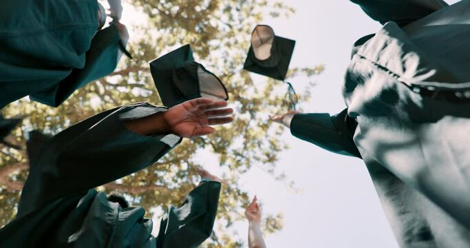 Students, low angle and throw graduation cap in celebration with success, education and outdoor together. People, group and cheers with hat for motivation, university or college by trees at campus
