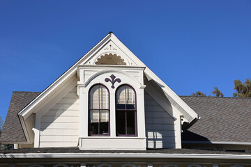 decorative dormer bay windows on a vintage victorian cottage