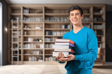 Portrait of smart teenage boy hold book