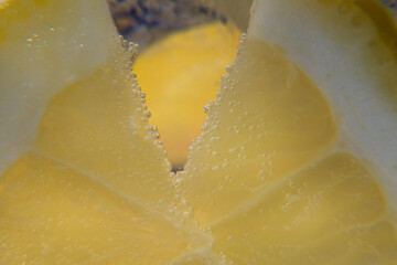 Close-up of a yellow lemon, bubbles of carbon dioxide, lemon drink