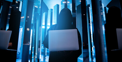 Male hacker in dark room using laptop internet hacking