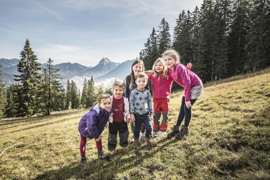 Group of kids posing together as a group while hiking in the mountains. Achenkirch, Austria