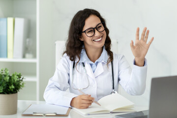 Cheerful young woman doctor have online consultation - obrazy, fototapety, plakaty