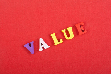 VALUE word on red background composed from colorful abc alphabet block wooden letters, copy space for ad text. Learning english concept.