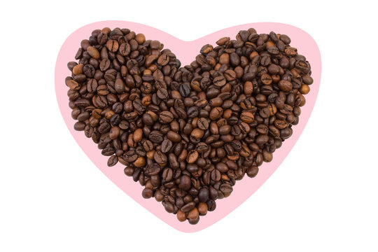 A pile of coffee beans in the shape of a heart on a white background. Top view.