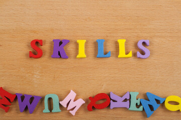 SKILLS word on wooden background composed from colorful abc alphabet block wooden letters, copy space for ad text. Learning english concept.