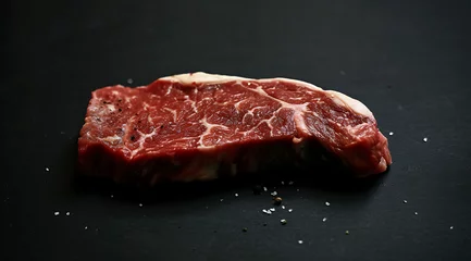 Foto op Canvas a sirloin steak slice on black dark background in © AQsd