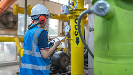 Maintenance technician at a heating plant,Petrochemical workers supervise the operation of gas and oil pipelines in the factory,Engineers put hearing protector At room with many pipes