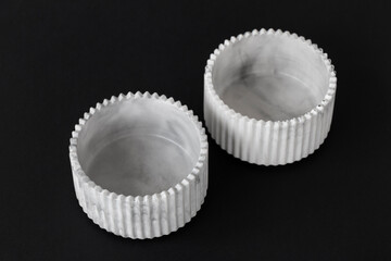 Handmade plaster candlestick, close up on isolated black background