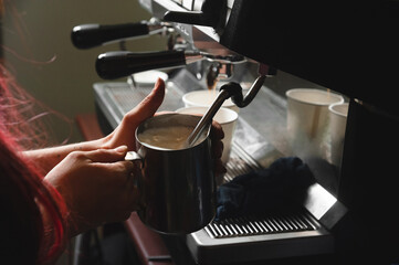 Frothing milk for coffee in a professional coffee machine