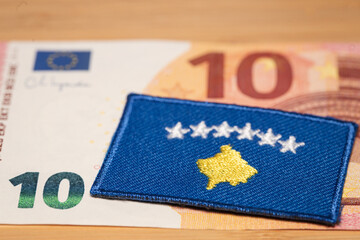 The flag of Kosovo against the background of the common currency of the European Union, the concept of Kosovo's accession to the euro zone