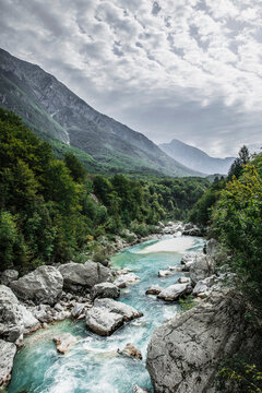 Aerial view of the Soca River in the Soca Valley, with blue green colored river, forests and mountains. Soca Valley, Slovenia