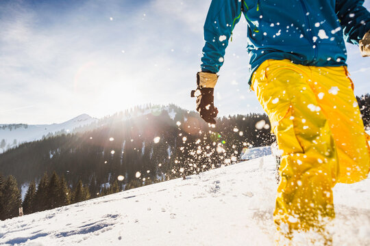 Man running through the deep snow on a mountain. Achenkirch, Tirol, Austria