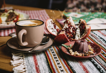a cup of cocoa, pudding and pomegranate, chocolate puding in the glass with pomegranate.Supangle or pudding