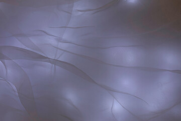 Blue or slightly purple light patches, blurred abstract background with shadows of highlighted...