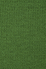 Fototapeta premium Green close-up texture knitted wool fabric background macro