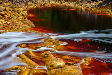 Foamy Waters Flowing Over Rio Tinto's Mineral-Rich Rocks