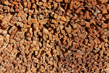Sorted firewood in remote alpine village of Sauris di Sotto in Carnic Alps, Friuli Venezia Giulia, Italy. Serene tranquil atmosphere in Italian Alps. Split logs stacked up against a wooden house
