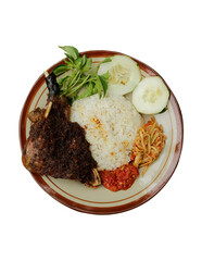 local Indonesian food fried duck with black spices typical of Madura with rice, fried chili sauce and mango chili sauce isolated on white