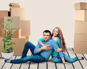 Portrait Of Smiling Young Couple Among Boxes in New Home