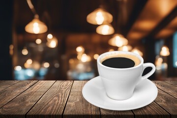 Wooden table at coffee shop  with a cup