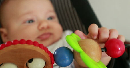 Fototapeta na wymiar Baby hand playing with toy