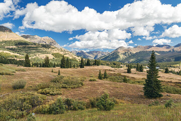 Rocky Mountain panoramic landscape of mountains, forest and valley with blue sky and clouds during autumn in Colorado, USA.   