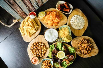 Wooden Table Topped With Plates of Food