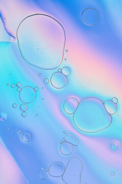 Iridescent colorful abstract background with bubbles, fluid texture pastel tones curvy wavy good vibes
