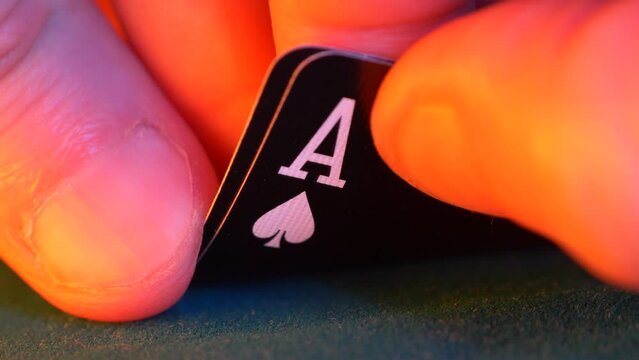 hand holds pair of aces, spades and hearts in a game of texas hold em poker