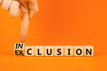 Inclusion or exclusion symbol. Concept word Exclusion and Inclusion on wooden cubes. Businessman hand. Beautiful orange table orange background, copy space. Business inclusion or exclusion concept.
