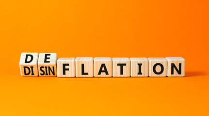 Deflation or disinflation symbol. Concept word Deflation Disinflation on beautiful wooden cubes. Beautiful orange table orange background. Business deflation disinflation concept. Copy space.