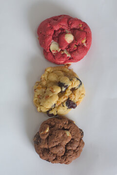 Three chocolate chip cookies of different flavors