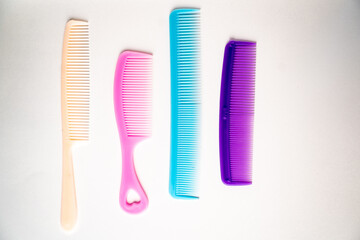 multi-colored hair combs on a white background