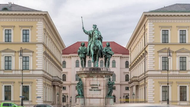 Monument Reiterdenkmal of King Ludwig I of Bavaria timelapse, which is located at the Odeosplatz in Munich, Germany. Front view with historic buildings on a background.