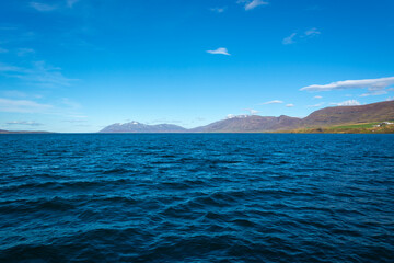 Norwegian fjord landscape with mountains and blue sky in summer
