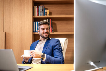 Fototapeta na wymiar Portrait of businessman in the office drinking coffee.