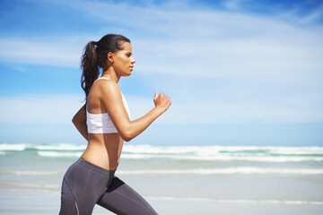 Fitness, Indian or woman on beach running for exercise, training or outdoor workout at sea. Sports...