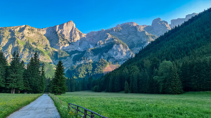 Hiking trail along alpine meadow with scenic view of majestic mountains of Hochschwab Region, Upper...