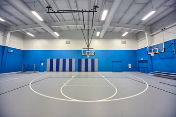 Modern Indoor Basketball Court with Blue Accents and Bright Lighting