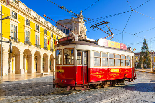 General view of the vintage Red Tram no. 28 with the Triumphal Arch of the main square Praca do Comercio behind, in Lisbon, Portugal, on December 27 2024.