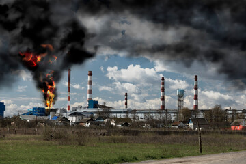 Fire and black smoke at the factory after the explosion. Black smoke rises high into the sky....