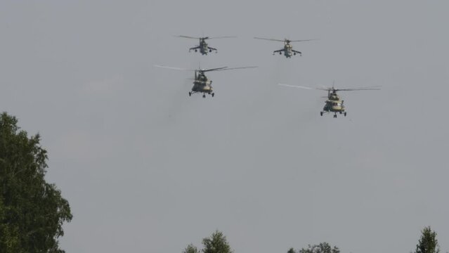 Military helicopters flying in sky performing demonstration flight, airforce, copy space. Group combat helicopters, aerobatic team performs flight at air show