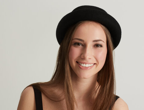 Woman, fedora and fashion with portrait in studio with confidence, pride and retro style by white background. Hipster girl, model or person with trendy hat, clothes and happy with face in Argentina