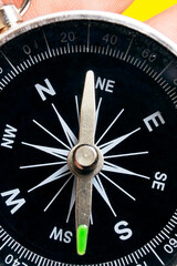 Compass in hand on a yellow background